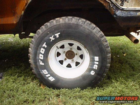Tire with 'BIG FOOT XT' text on a vehicle