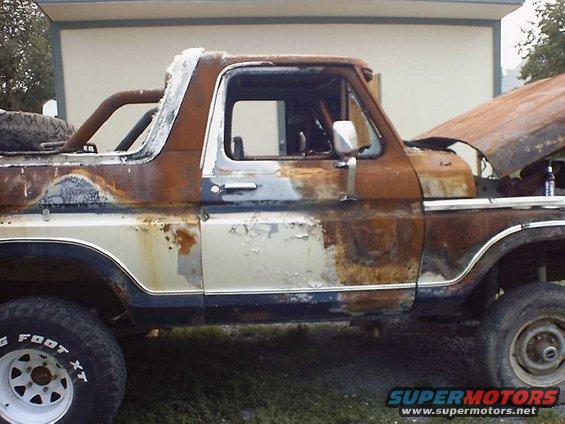 Side view of a heavily rusted 1978 Ford Bronco with the hood open