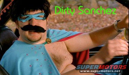 Man wearing a blue mask and mustache costume drives a vehicle