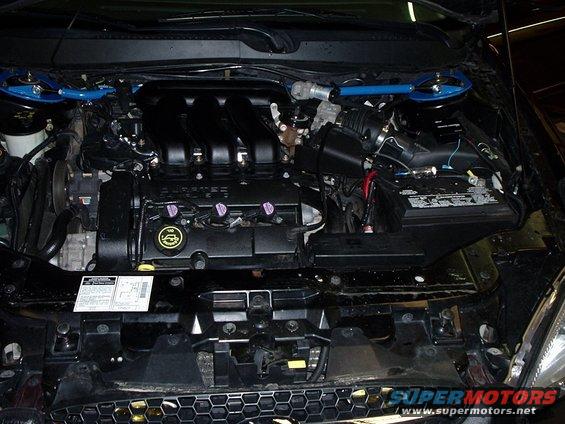 Engine bay with V6 engine, battery, and blue strut bar