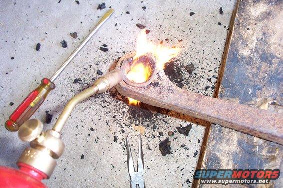 Step 3--Use one of those $10 torches that you find at the parts stores to burn out the rest of the bushing.  Burn it some, the use pliers and a scraper to get the rubber out.  Repeat until there's almost nothing left.