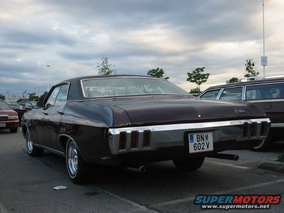 Dark colored 1970 Chevrolet Impala parked, rear view. License plate BN 602 V