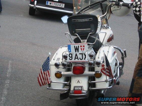 White motorcycle rear with American flags and license plate W 9 AJX