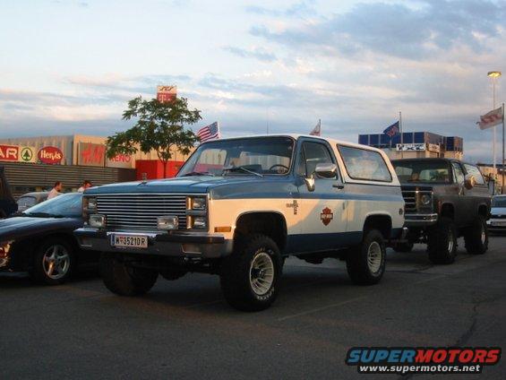 Two-tone blue and white Chevy K5 Blazer parked next to another SUV