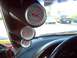 1992 Ford Probe - Three gauges are mounted on the dashboard of a car, with other vehicles seen outside.