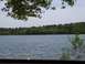 1990 Ford Bronco - View of a lake surrounded by trees, with two chairs placed near the water's edge.