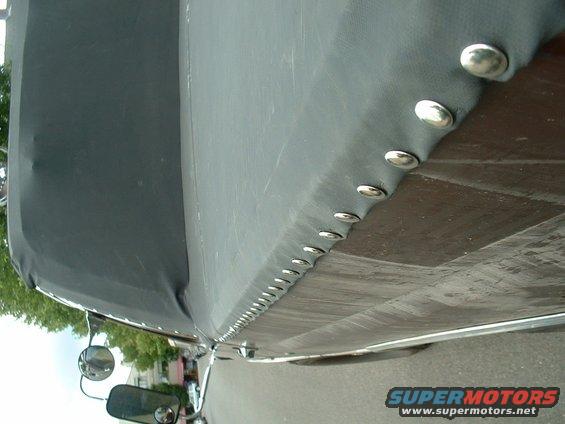 Side view of a vehicle with a black snap-on cover and chrome side mirrors