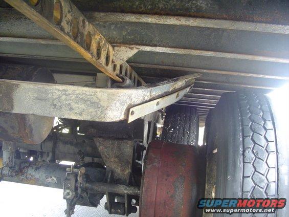 Undercarriage of a truck with visible suspension components and tires