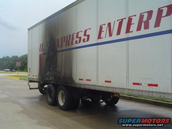 Trailer with fire damage and U.S. Xpress Enterprises logo