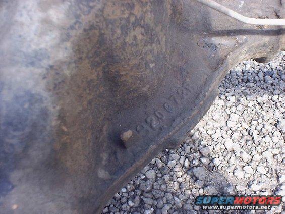 Cast iron part with stamped numbers '120072'. Gravel visible in background