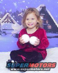 Child in red shirt holding two snowballs, seated in front of a winter scene backdrop with SuperMotors logo