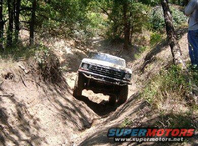 1978 Ford Bronco navigating a muddy ditch