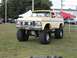 1994 Ford Bronco - This modified Ford Bronco features a significant lift kit and oversized tires, giving it a commanding presence.