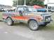 1994 Ford Bronco - This Ford Bronco features a distinctive orange and red gradient paint scheme on its side.