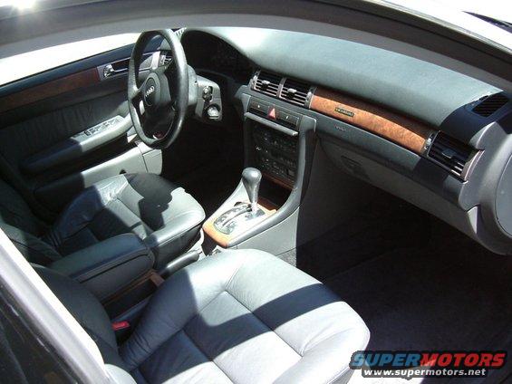 Interior of a 1999 Audi A6 with leather seats and wood trim