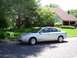 1999 Audi A6 - A silver 1999 Audi A6 is parked on the street in front of a suburban home.