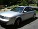 1999 Audi A6 - This 1999 Audi A6 sedan is parked outside a home with trees and flowers in the background.