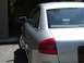 1999 Audi A6 - The rear of a silver Audi A6 sedan is shown, with a partial view of a garage in the background.