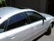 1999 Audi A6 - A silver sedan is parked outside a garage, showing its side profile and tinted windows.