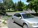1999 Audi A6 - This silver 1999 Audi A6 sedan features a sunroof and is parked on a paved driveway.