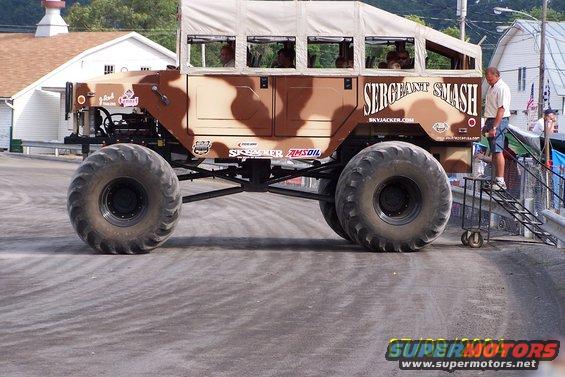 Monster truck with camouflage paint and "SERGEANT SMASH" text, large tires, and canvas top