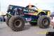 1979 Ford Bronco - The 'Black Stallion' monster truck features a custom paint job and oversized tires, indicating it's built for off-road competition.