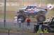 1979 Ford Bronco - A monster truck with "Summit Truck Style" branding is parked on a dirt lot with spectators nearby.