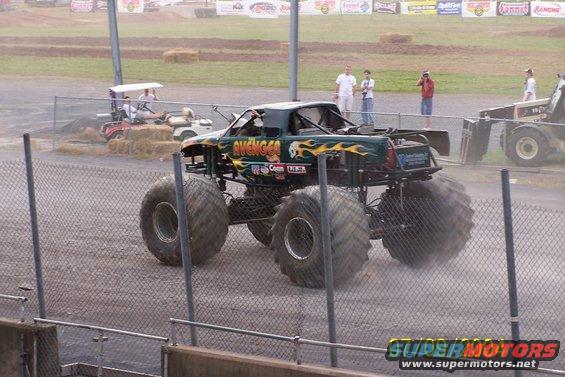 Green monster truck with flames and 'AVENGER' text