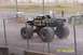 1979 Ford Bronco - Monster truck named 'AVENGER' with flame graphics drives on a dirt track.