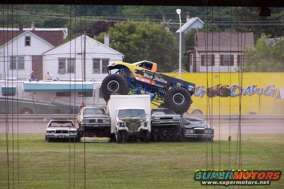 Monster truck named Black Stallion crushing cars