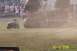 1979 Ford Bronco - A monster truck event with a vehicle overturned on the field, an ATV and golf cart also present.