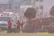 1979 Ford Bronco - A monster truck event is underway with spectators and emergency vehicles present.