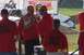 1979 Ford Bronco - Event officials in red shirts stand near a damaged vehicle at an outdoor event.