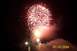 1979 Ford Bronco - A bright fireworks display illuminates the night sky, with smoke and streetlights visible below.