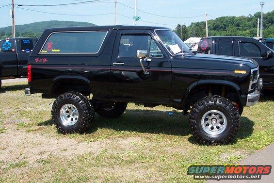 Black lifted 1979 Ford Bronco with red pinstripes and 4x4 decals