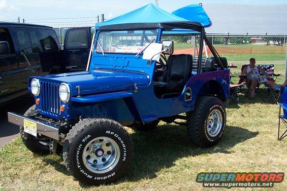 Blue Jeep with a blue canopy top and off-road tires