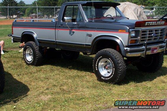 Lifted Ford F-150 pickup truck with two-tone paint and off-road tires