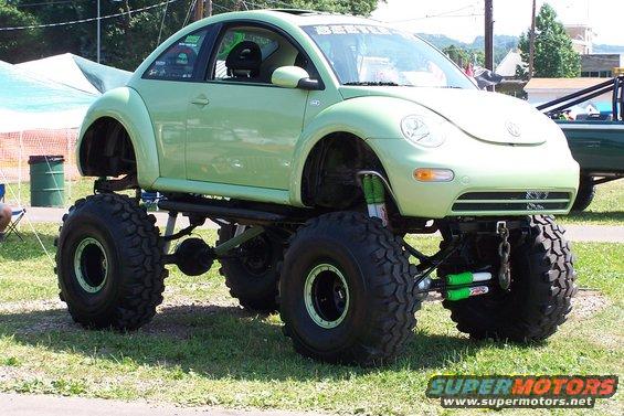 Light green Volkswagen Beetle on a monster truck chassis with large off-road tires