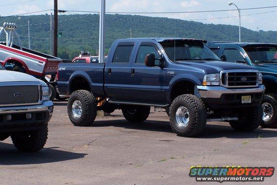 Blue lifted Ford F-250 Super Duty pickup truck with large tires