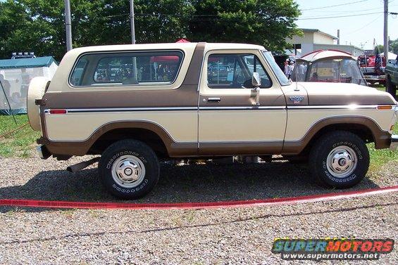 Side view of a 1979 Ford Bronco in tan and brown with a spare tire