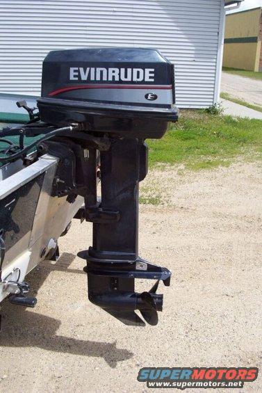Black Evinrude outboard motor attached to the rear of a boat, showing the propeller and lower unit