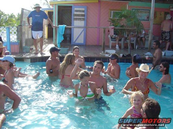 People swimming and drinking at a tropical bar