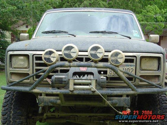 Gray Ford Bronco front end with winch and four auxiliary lights