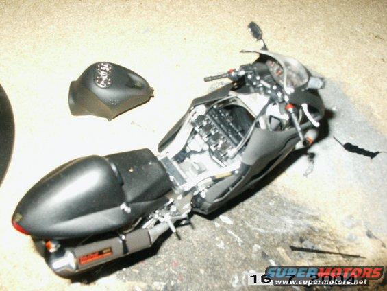 Black motorcycle with detached fuel tank and exposed engine