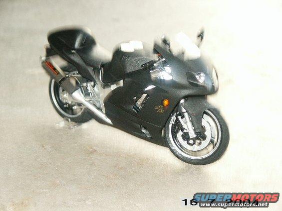 Black sport motorcycle with chrome exhaust and visible engine components
