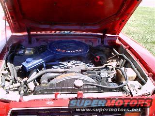 Red engine bay with blue air cleaner. Supermotors.net watermark visible
