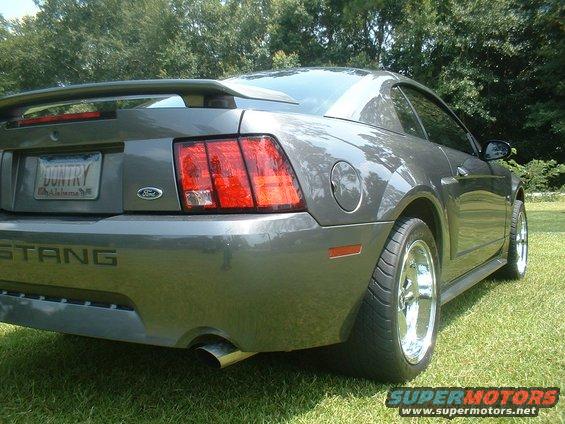 2003 Ford Mustang rear view with spoiler and chrome wheels