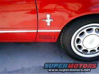 Red car fender with a horse emblem and MACH 1 text on the side