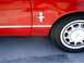 1978 Ford Mustang II - Close-up of a red car's side panel, showing the MACH 1 badging and a horse emblem.
