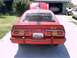 1978 Ford Mustang II - Rear view of a red 1978 Ford Mustang II with louvred windows and racing stripes.